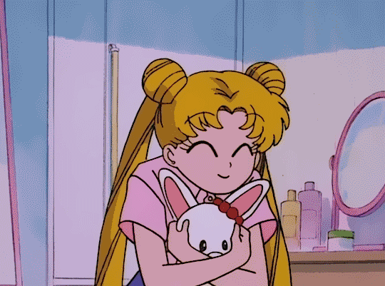 A gif of Sailor Moon, happily throwing a stuffed animal behind herself before posing several times